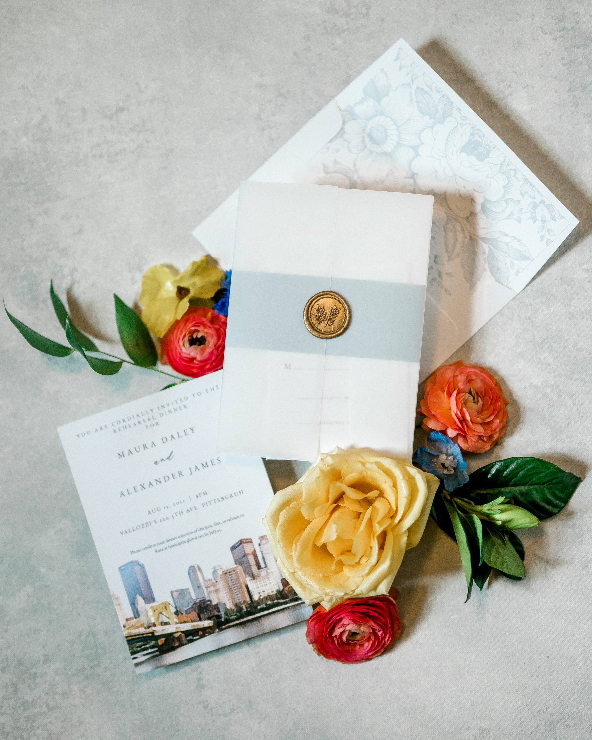 summer wedding invitation suite flatlay with bright colorful floral accents