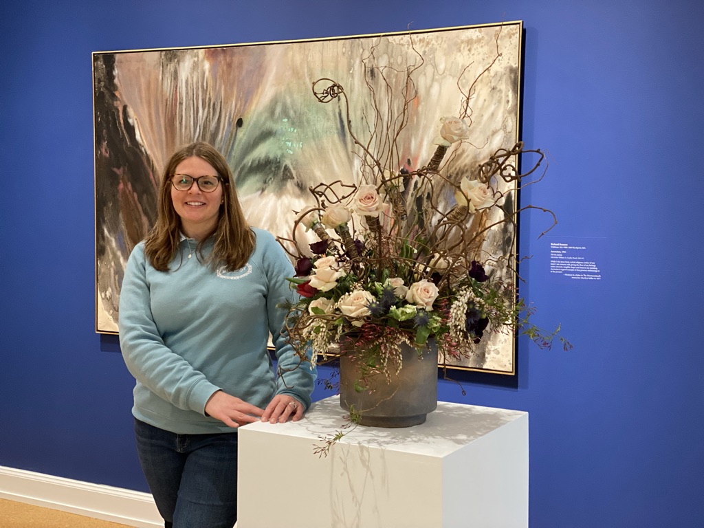 Stephanie Kirby owner of The Blue Daisy Floral Designs poses with her Art in Bloom design at Westmoreland Museum of American Art